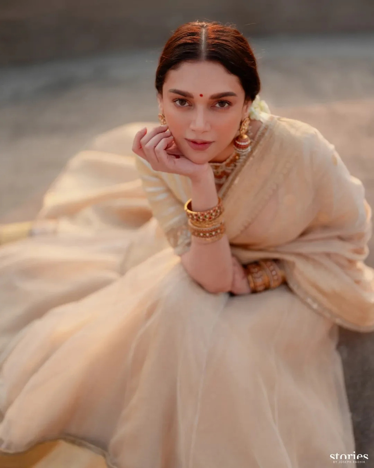 Aditi opted for a gorgeous organza lehenga in beige with a golden Zari border